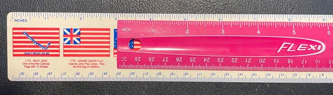 Two flag-decorated rulers positioned to demonstrate addition