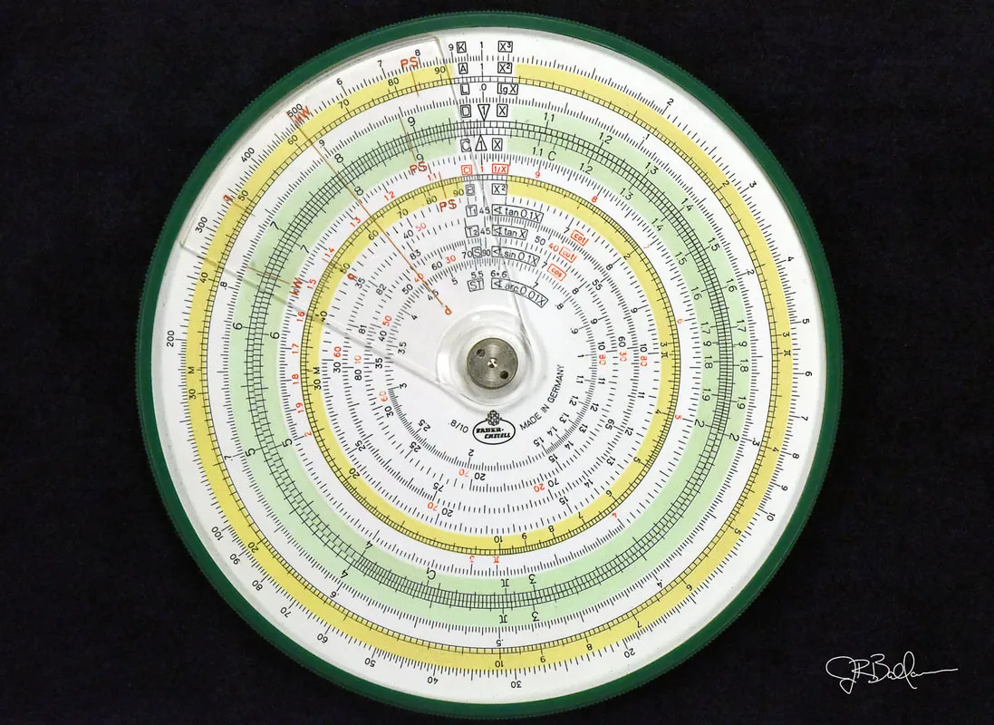 Close-up of a Faber-Castell 8/10 circular slide rule with Jay's cursive signature
