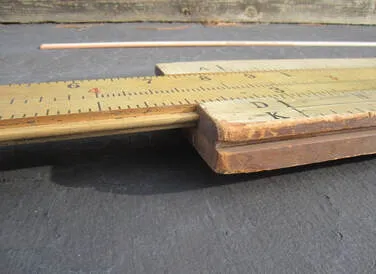The earlier Model 101 demonstration rule made of thick, light-colored softwood