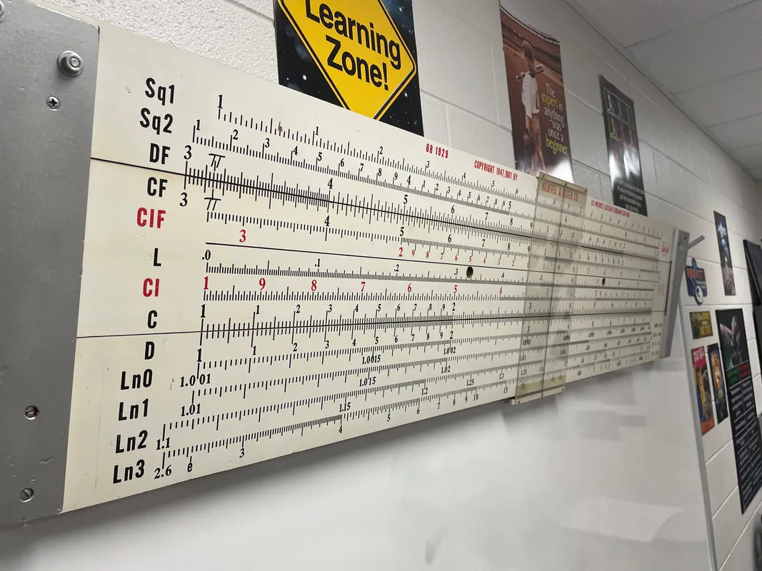 The author's 6.5-foot redwood Deci-Lon 10 demonstrator rule hanging in his classroom, front side