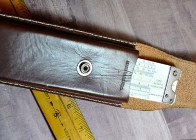 A closer view of a leather case and identification tag from a U.S.-marked D4053-3 rule