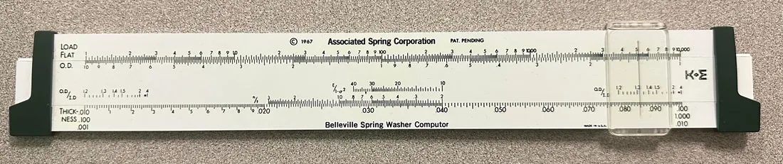 The front side of the Belleville Spring Washer Computor, showing the Load Flat, O.D., and Thickness scales