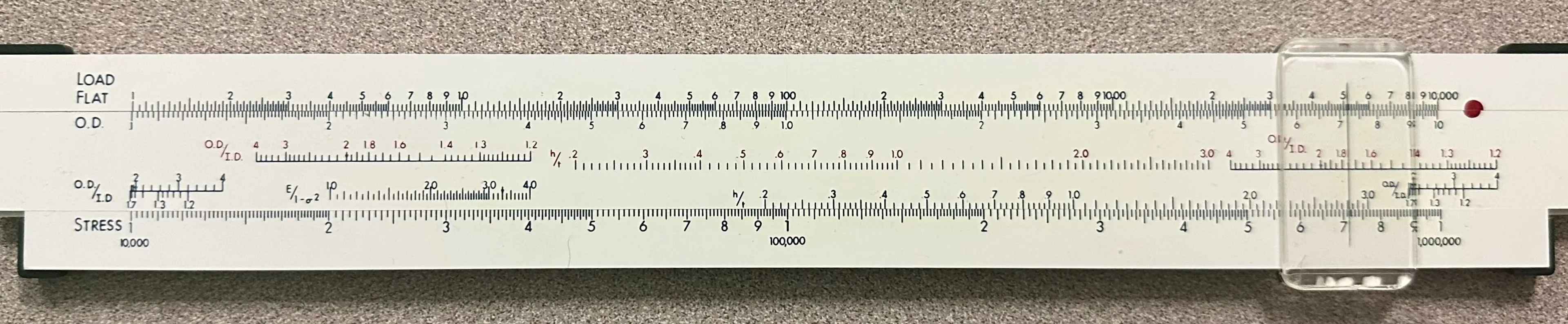 The back side of the Belleville Spring Washer Computor, showing the Load Flat, O.D., and Stress scales