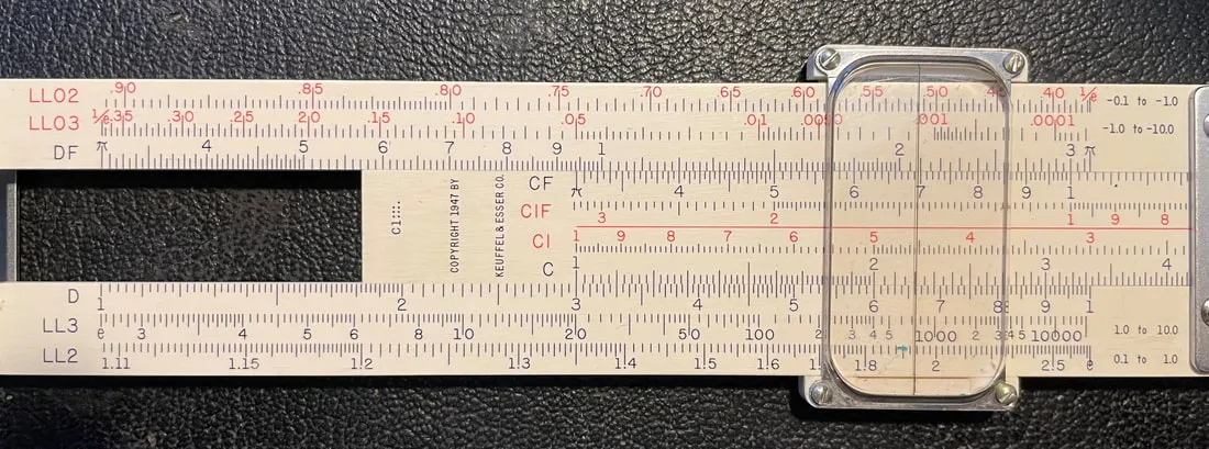 K&E Jet-Log pocket slide rule with the C-scale index aligned to the D-scale to compute a product