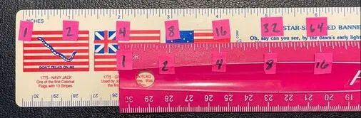 Two rulers labeled with powers of two, positioned to demonstrate multiplication
