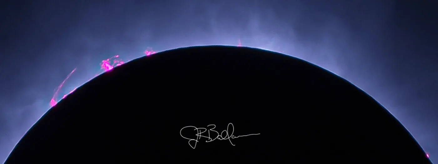 Closeup of solar prominences along the lunar limb during totality