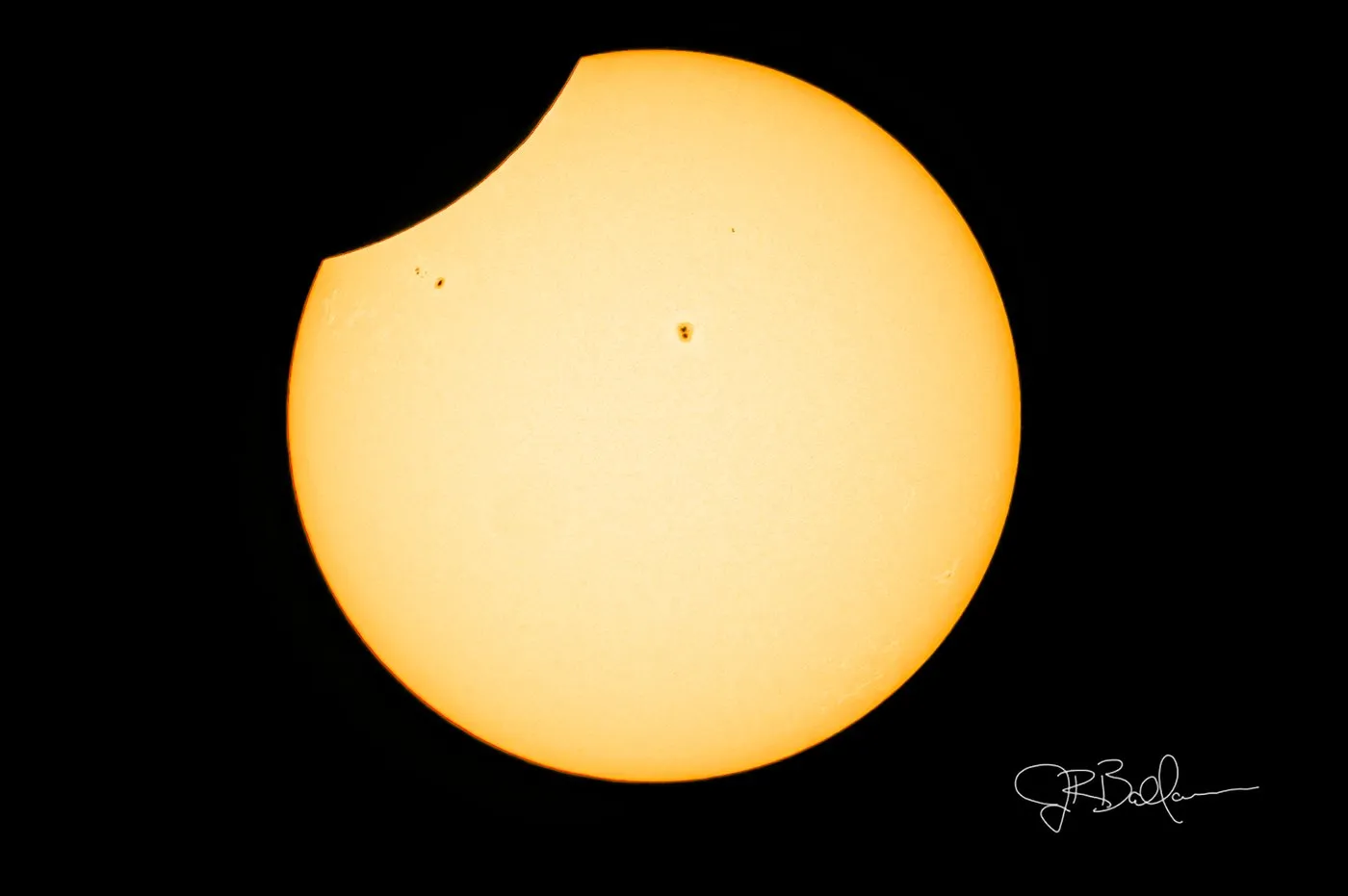White light view of the solar disk with sunspots, nearing 4th contact